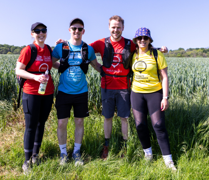 A group of people smiling in a field