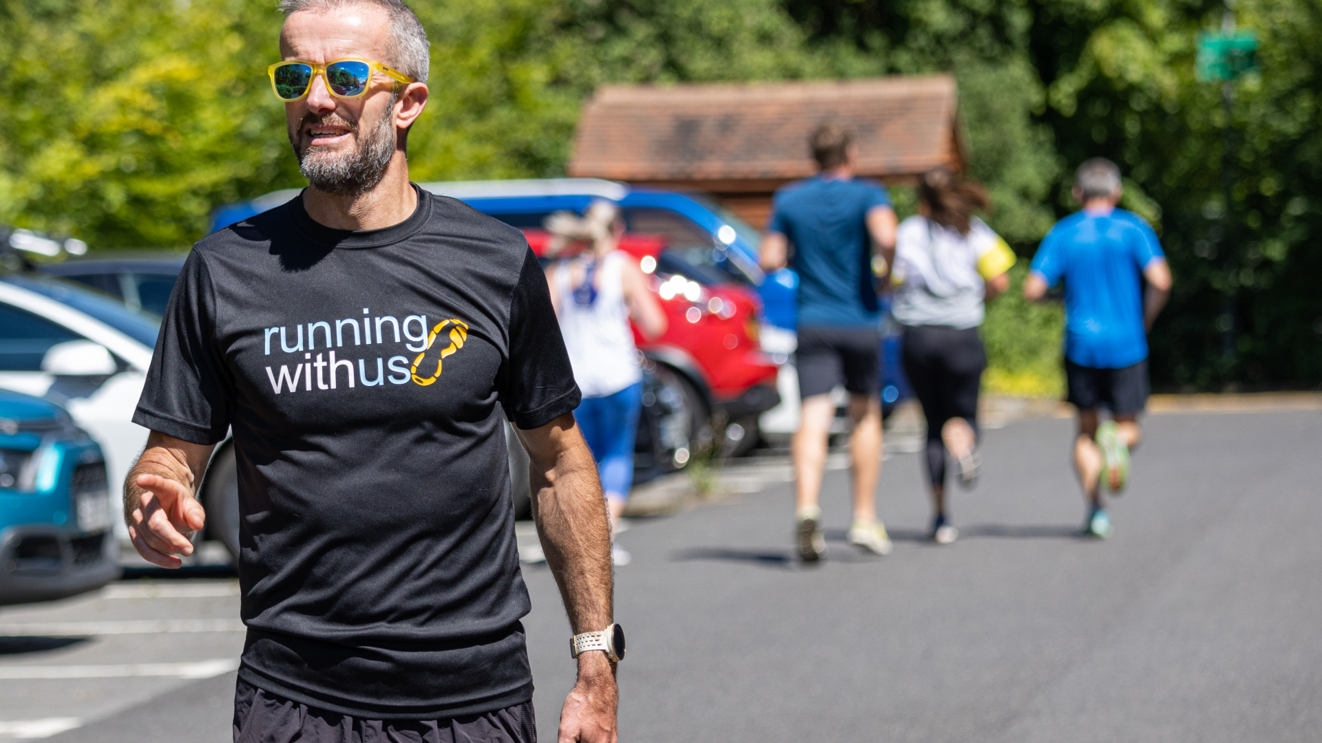 Nick Anderson in hospice car pak with runners behind him