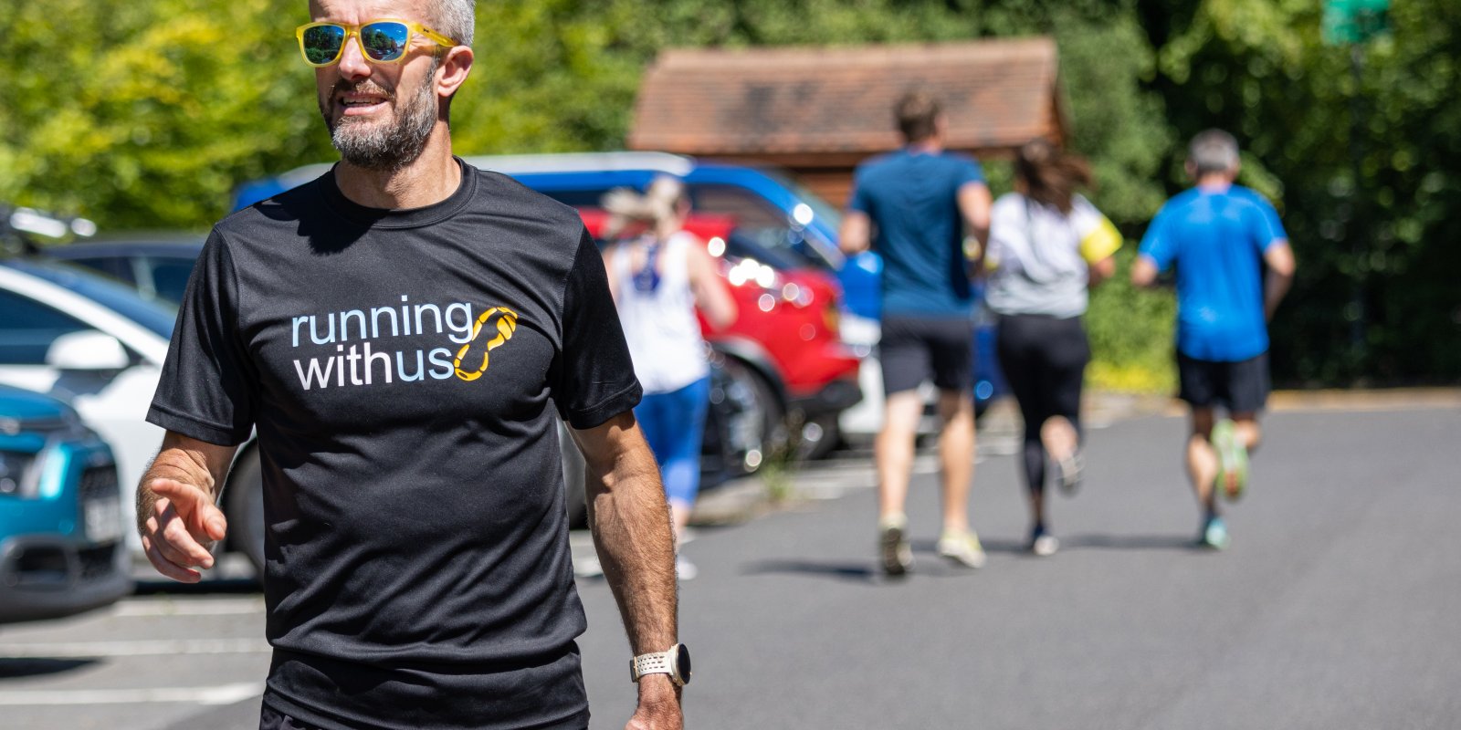 Nick Anderson in hospice car pak with runners behind him