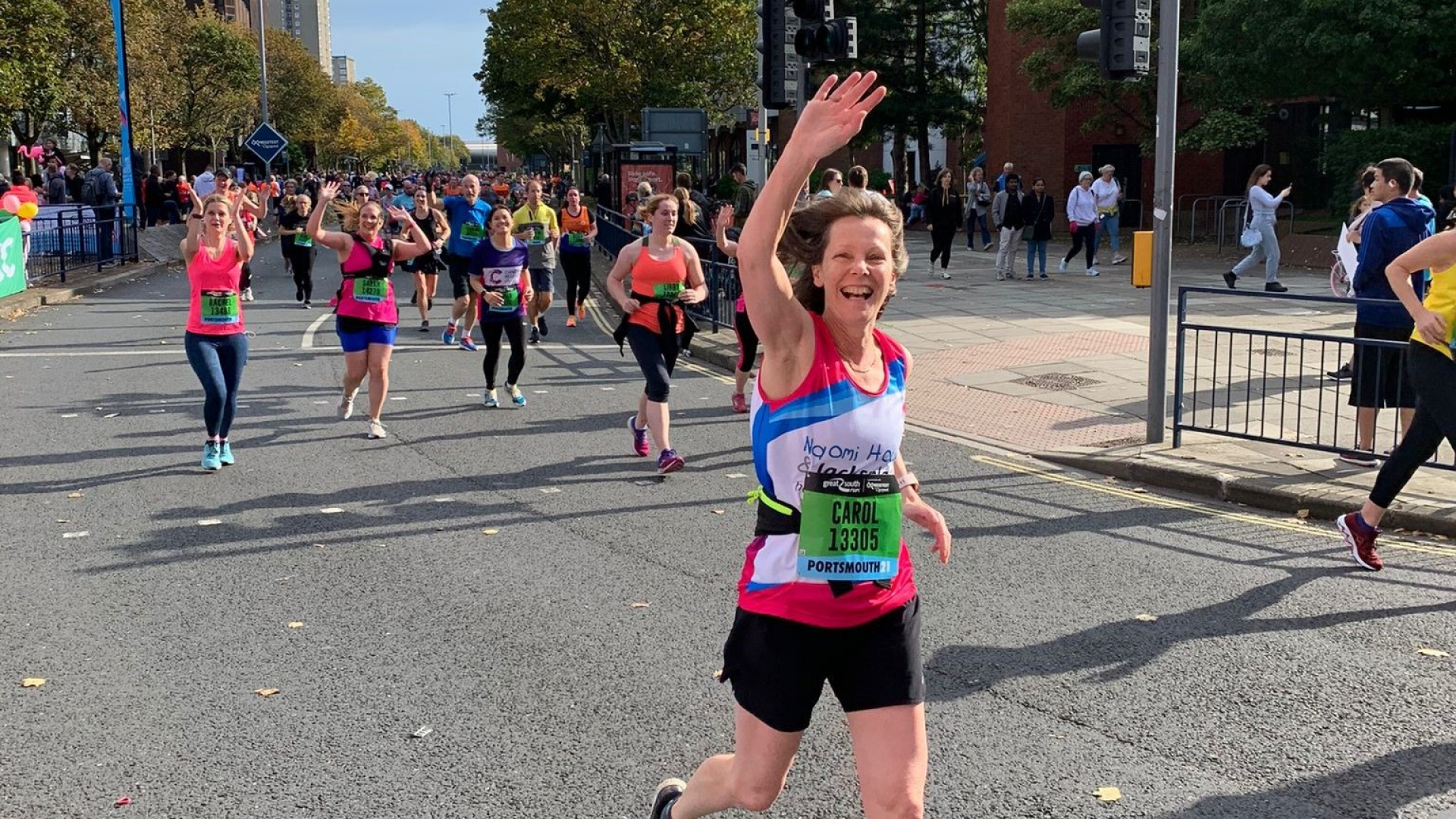 women waving to the camera in the great south run